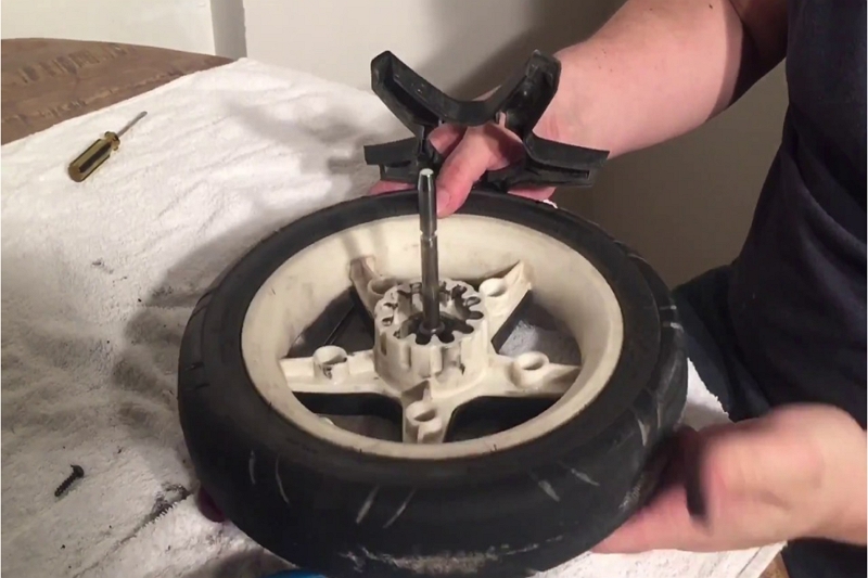 Remove a Hub Cap from a Stroller Wheel
