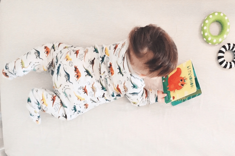 How can reading a book to a baby contribute the baby's development